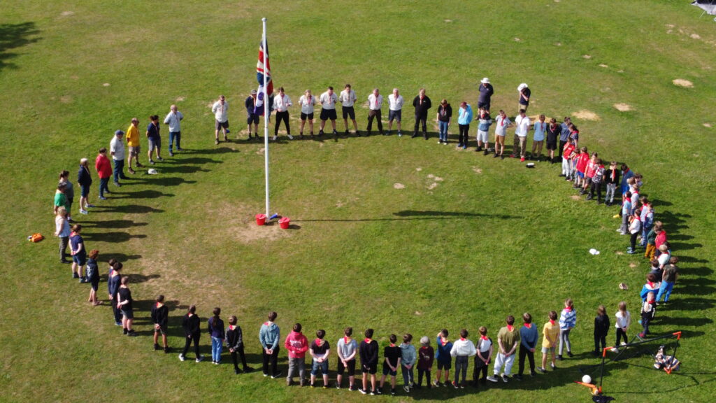 Liphook Scouts in a circle around a flagpole